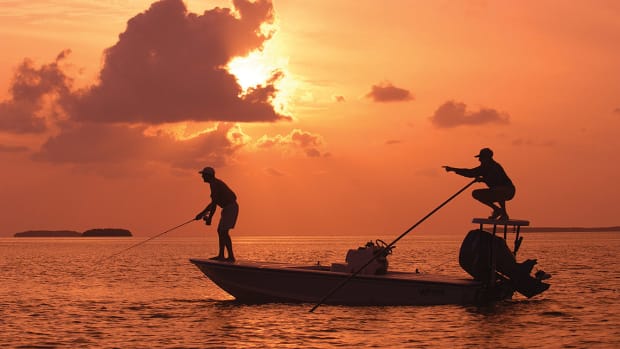 As the sun sets, a Florida Keys bonefish guide, right. points his angler to a bonefish on fly tackle off Islamorada in the Florida Keys. More than 200 International Game Fish Association saltwater world records have been set in the Florida Keys. (Photo by Bob Krist/Florida Keys News Bureau)
