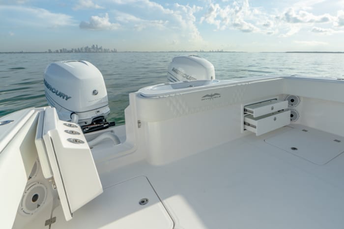 The transom door provides easy access to the engines, while a livewell and tackle drawers add to the fishability. 