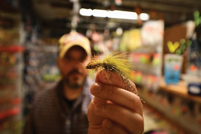 Choosing a fly at Coop's Bait and Tackle.