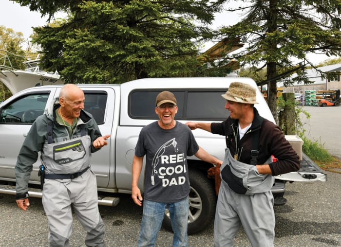 Todd Cascone, Danny Gilkes and Aron Cascone (from left) take a break from hunting striped bass share a laugh.