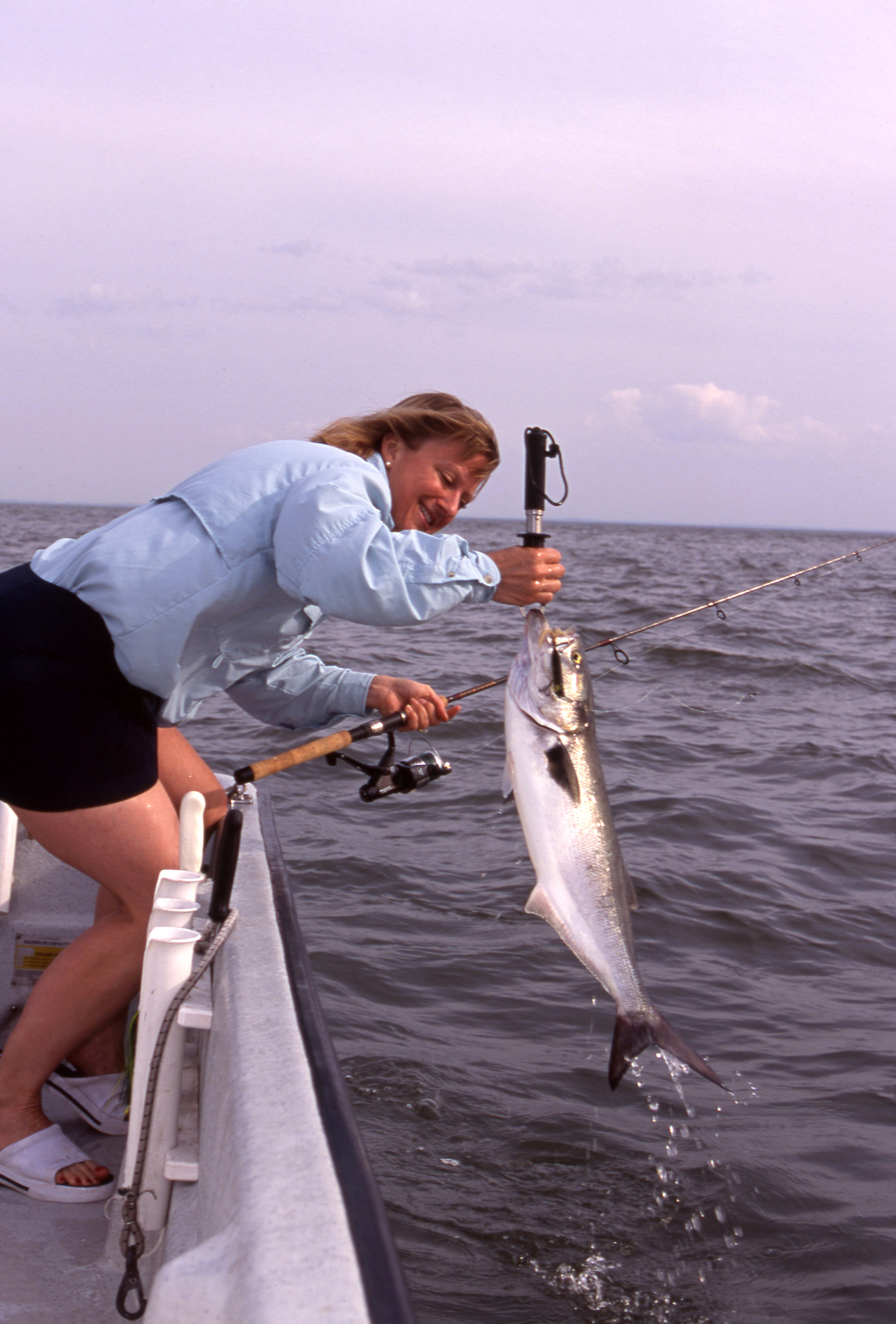 Carol Migdalski with a blue, smaller but reminiscent of the one she caught on her first fishing date.