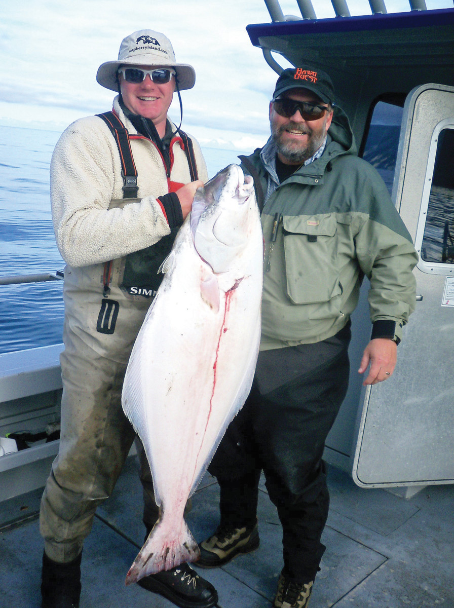 Author Kris Olsen (right) with a Kodiak Island halibut.