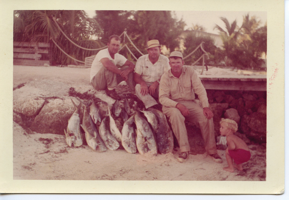 The author (in red shorts) at Breezy Palms Resort. His father, Dr. Harry Brownlee, (third from left) and friends with a nice pile of dolphin.