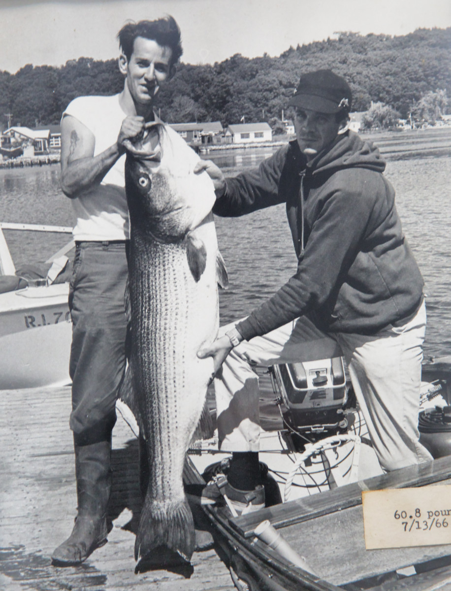 An early client with a large striped bass (Anderson is at right).