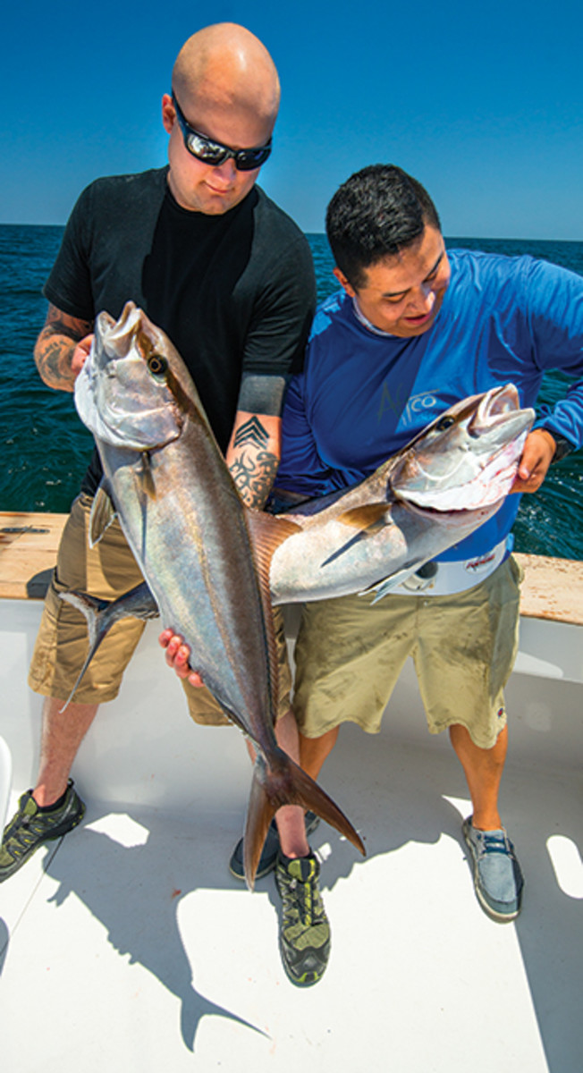 Vernon Miller (left) and Steven Diaz with a matched pair of amberjacks.