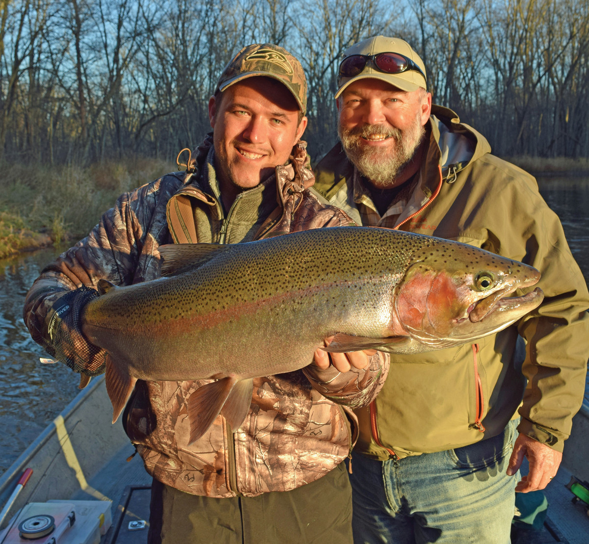 The author (right) and his son with a fat Michigan steelhead.