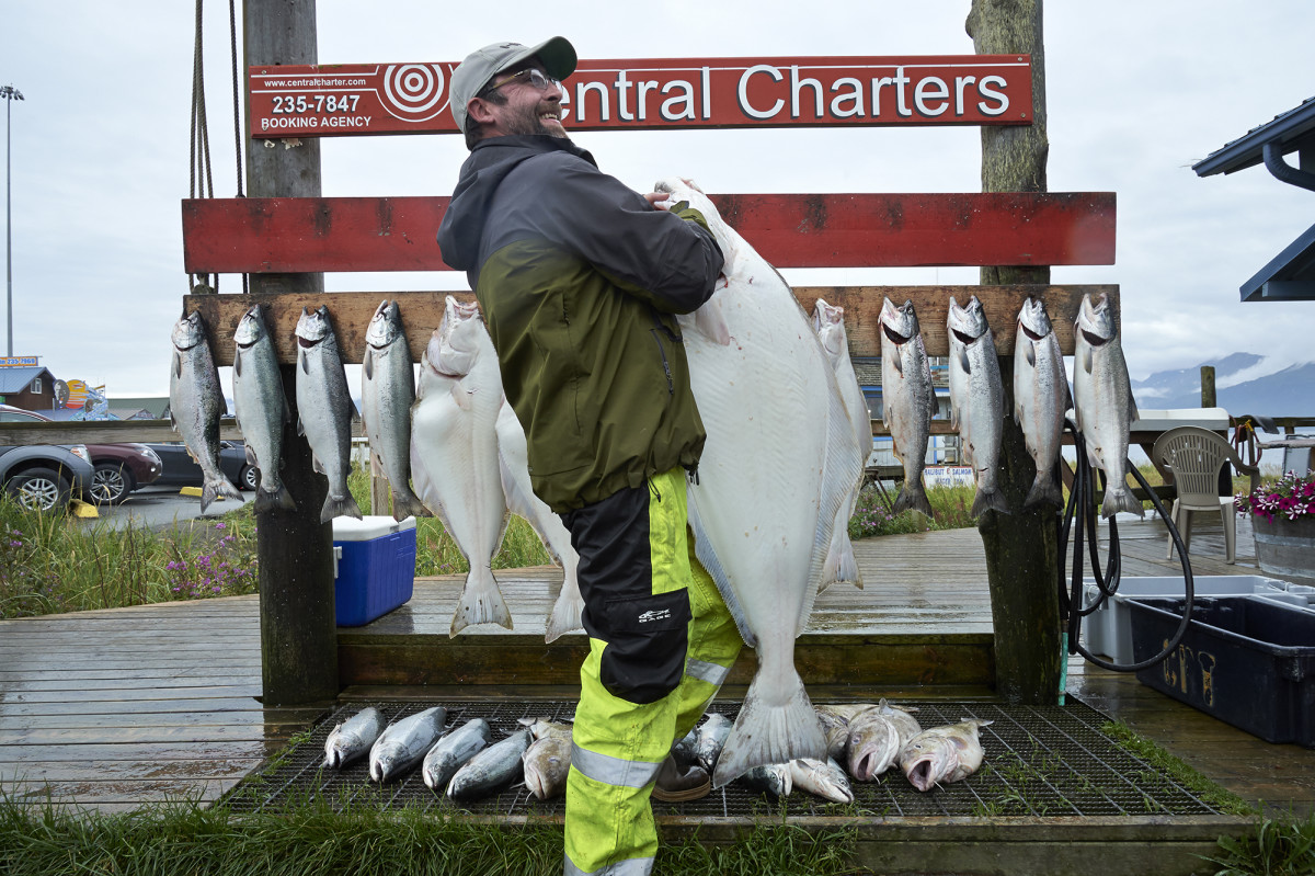 Hugh Hestand hoists a 70-pound halibut caught with “fish whisperer” Capt. David Mayes. 