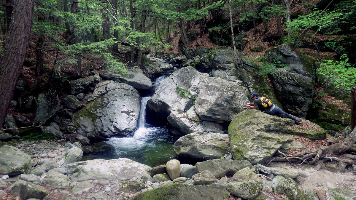 Noah Davis adjusts to the contours of a small stream in Vermont.