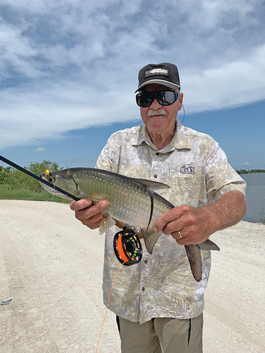 Clouser with a typical juvenile tarpon taken with one of his popping bug flies from an area of the Merritt Island National Wildlife Refuge he calls "The Jungle."