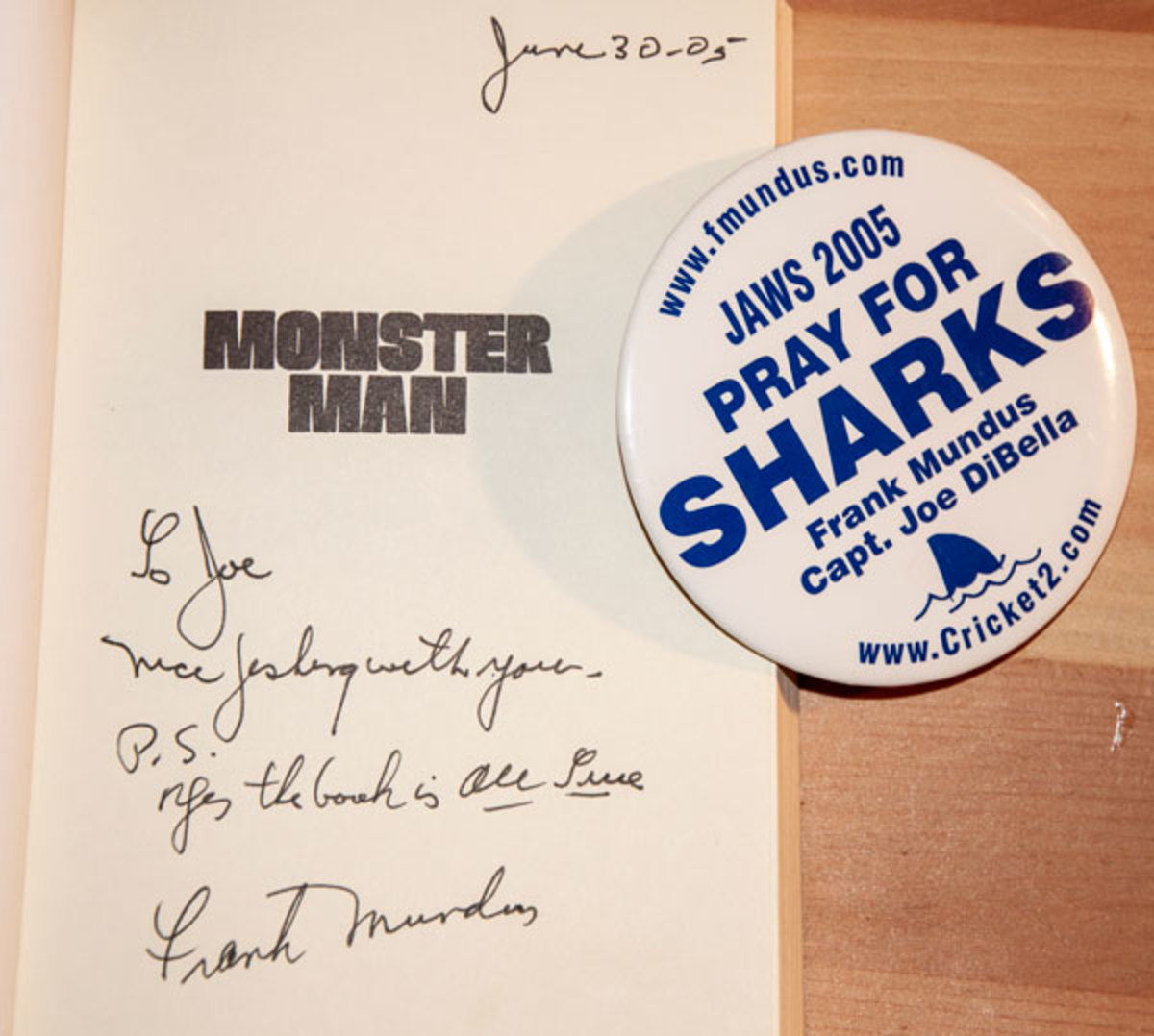 One of the author's cherished mementos is a signed copy of Monster Man and a button from the trip.