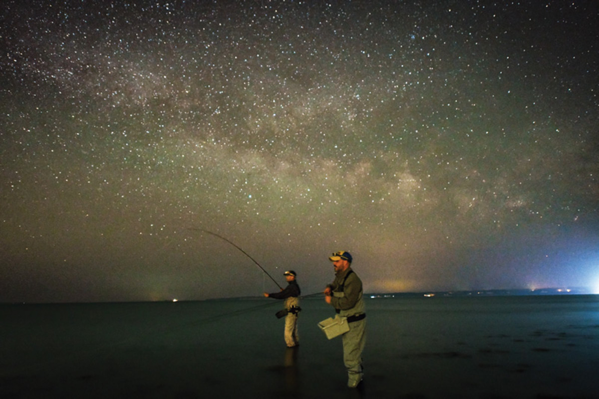 With fishing allowed from 7 p.m. to 2 a.m., every minute counts. The writer (right) and Brian McCarty work the shallows. 