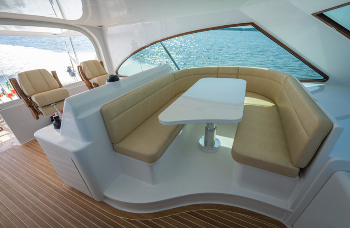 The lower helm features a U-shaped dinette forward of the helm. 