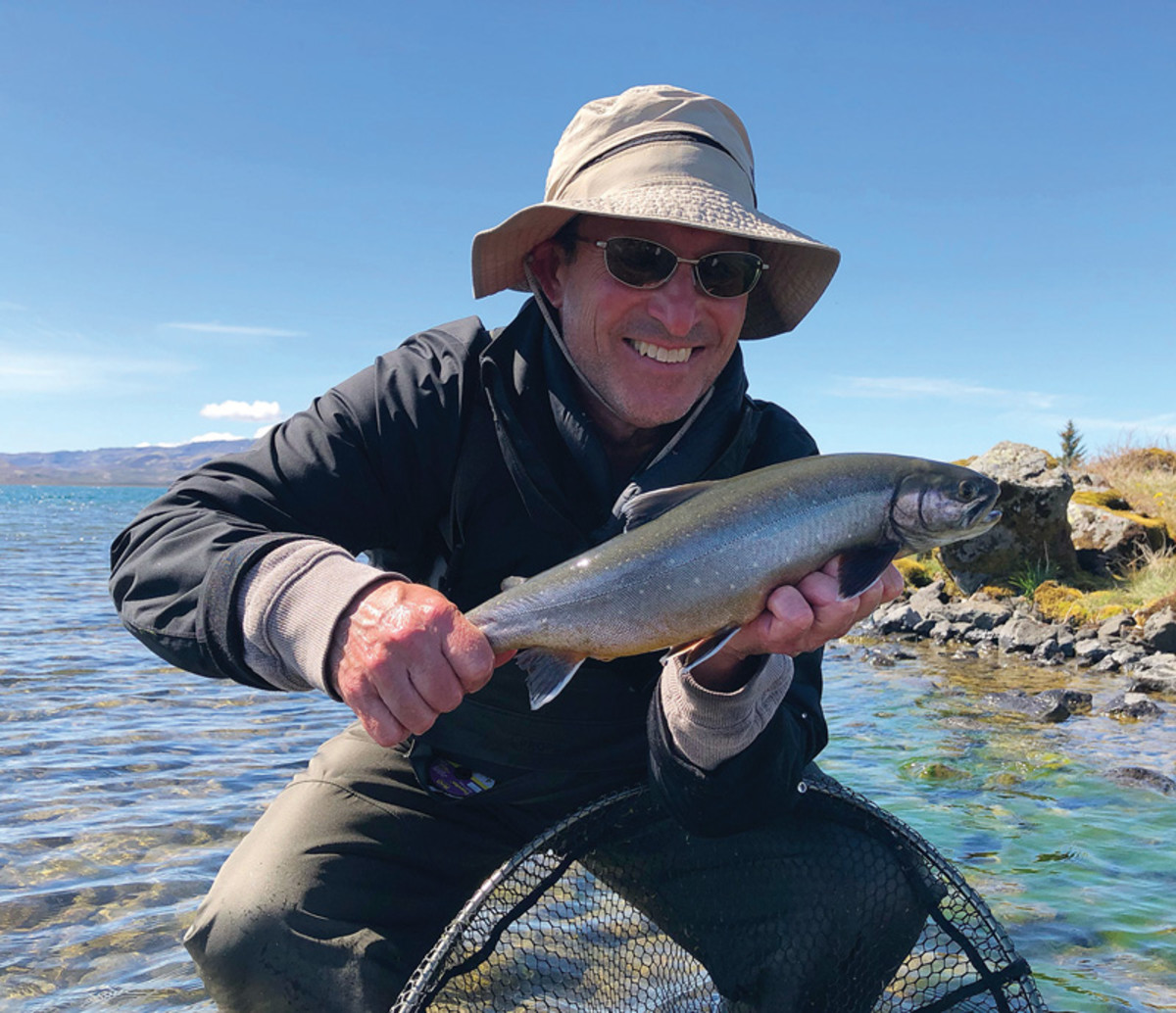 The writer, Henry Hughes, with a fresh-caught Arctic char. 